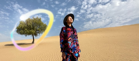 iPad Pro, front exterior display with dark blue and green gradient background with multiple apps open, hand holding Apple Pencil Pro circling a sketch showing Apple Intelligence Image Wand feature