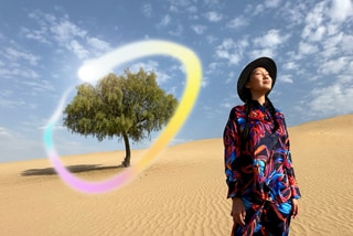 iPad Pro, front exterior display with dark blue and green gradient background with multiple apps open, hand holding Apple Pencil Pro circling a sketch showing Apple Intelligence Image Wand feature